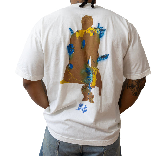 Person wearing a white t-shirt with a colorful graphic on the back, standing against a white background.