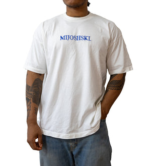 Person wearing a white t-shirt with 'MIJOSHSKI' embroidered on it against a white background